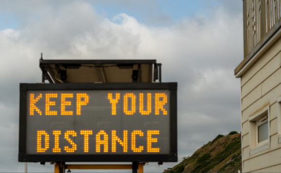 A digital road sign displays the text 